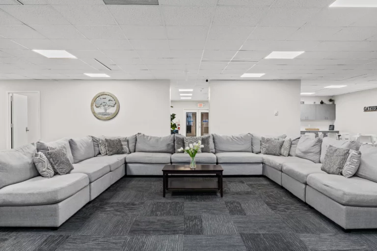 Group meeting area with large, U-shaped couch in the middle of a large room at Legacy Healing Center’s Cherry Hill drug and alcohol rehab center